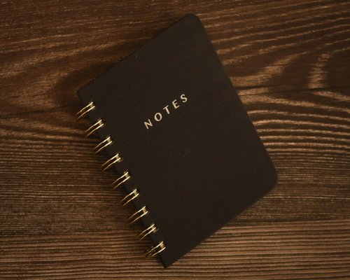 planning daily goals in notebook with coffee